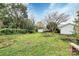 Lush backyard with mature trees and a storage shed, offering a private outdoor space at 105 Deaver St, Chester, SC 29706