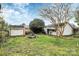 View of a backyard featuring a small white shed, table, and grassy area, offering outdoor space at 105 Deaver St, Chester, SC 29706