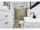 Bright bathroom with updated fixtures, shower/tub combo, and storage at 105 Deaver St, Chester, SC 29706