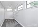 The neutral-toned room includes three windows and closet shelving for organization at 105 Deaver St, Chester, SC 29706