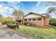 A one-story brick house is accented with lush, manicured front yard landscaping at 105 Deaver St, Chester, SC 29706