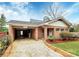 A cozy brick home has a carport and is surrounded by well-maintained landscaping at 105 Deaver St, Chester, SC 29706