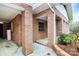 The brick home features an open carport and is surrounded by lush landscaping at 105 Deaver St, Chester, SC 29706