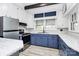 Modern kitchen with stainless steel appliances, blue cabinets, and bright countertops at 105 Deaver St, Chester, SC 29706