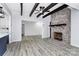 Open concept living room showcases a brick fireplace and hardwood floors at 105 Deaver St, Chester, SC 29706