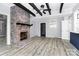 Spacious living room features a brick fireplace, ceiling beams, and light wood floors at 105 Deaver St, Chester, SC 29706