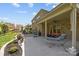 Beautiful backyard with a covered patio, outdoor furniture, and a cozy hanging chair at 10904 Kilkenny Dr, Matthews, NC 28105