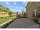 Spacious backyard featuring a brick fireplace, patio, and well-maintained landscaping at 10904 Kilkenny Dr, Matthews, NC 28105
