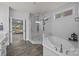 Bathroom featuring a glass door shower, white tub, and vanity at 10904 Kilkenny Dr, Matthews, NC 28105