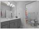 Well-lit bathroom featuring a double vanity, a large mirror, and a separate room for toilet and shower at 10904 Kilkenny Dr, Matthews, NC 28105