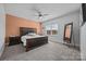 Inviting bedroom with a large bed, stylish mirror, and ample natural light from the window at 10904 Kilkenny Dr, Matthews, NC 28105