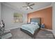 This bedroom has a window with natural light and a gray tufted headboard at 10904 Kilkenny Dr, Matthews, NC 28105