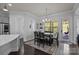 Bright dining area with stylish rug, modern chandelier, and natural light at 10904 Kilkenny Dr, Matthews, NC 28105
