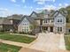 Two-story home with manicured lawn, stone accents, and a spacious driveway at 10904 Kilkenny Dr, Matthews, NC 28105
