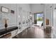 Bright foyer with dark hardwood floors, white trim, and a view of the home's exterior at 10904 Kilkenny Dr, Matthews, NC 28105