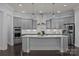 Spacious kitchen with gray cabinets, stainless steel appliances, and large center island at 10904 Kilkenny Dr, Matthews, NC 28105