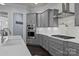 Well-equipped kitchen with gray cabinetry, stainless steel appliances, and ample counter space at 10904 Kilkenny Dr, Matthews, NC 28105