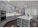 Modern kitchen featuring gray cabinetry, stainless steel appliances, and a large kitchen island at 10904 Kilkenny Dr, Matthews, NC 28105