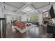Open-concept living room with coffered ceilings, fireplace, and ample seating at 10904 Kilkenny Dr, Matthews, NC 28105