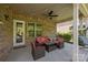 Charming covered patio with stylish wicker furniture and string lights, ideal for outdoor relaxation at 10904 Kilkenny Dr, Matthews, NC 28105