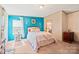 Cozy bedroom with colorful accent wall, plush bedding, and window offering natural light at 115 Oak Creek Rd, Statesville, NC 28625