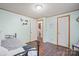 Well-lit bedroom with a cool mint color and dark floors offering entry to the hall and en-suite bathroom at 115 Oak Creek Rd, Statesville, NC 28625
