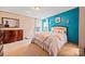 Well-lit bedroom featuring neutral walls, plush carpet, and matching furniture at 115 Oak Creek Rd, Statesville, NC 28625