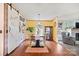 Charming dining room featuring a table with chairs, sliding barn door, and stylish decor at 115 Oak Creek Rd, Statesville, NC 28625