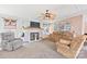 Comfortable living room featuring a fireplace, ceiling fan, and plush seating, perfect for relaxation at 115 Oak Creek Rd, Statesville, NC 28625