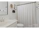 Clean bathroom featuring white cabinets, shower with patterned curtain and sleek fixtures at 116 Rainbow Trout Trl, Fort Mill, SC 29715
