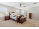 Bright bedroom with a bed, ceiling fan, and an en-suite bathroom provides comfort and convenience at 116 Rainbow Trout Trl, Fort Mill, SC 29715