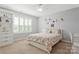 Cozy bedroom with built in bookshelves, a patterned comforter, and a large window for natural light at 116 Rainbow Trout Trl, Fort Mill, SC 29715