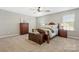 Comfortable bedroom with an antique chest, dresser, nightstands, and a ceiling fan above a made bed at 116 Rainbow Trout Trl, Fort Mill, SC 29715