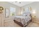 Comfortable bedroom with a window, neutral walls, and patterned bedding at 116 Rainbow Trout Trl, Fort Mill, SC 29715