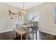 Open dining room with hardwood floors and sliding glass door to outdoor living at 116 Rainbow Trout Trl, Fort Mill, SC 29715