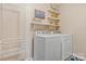 Functional laundry room with modern washer and dryer set, complemented by stylish wall decor and a laundry cart at 116 Rainbow Trout Trl, Fort Mill, SC 29715