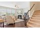 Well-lit living room with a fireplace and a staircase leading to the upper level at 116 Rainbow Trout Trl, Fort Mill, SC 29715
