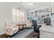 Bright home office with built-in bookshelves, comfortable seating, and a functional workspace at 116 Rainbow Trout Trl, Fort Mill, SC 29715