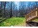 Backyard features stairs leading to lush greenery and mature trees at 1314 39Th Street Sw Cir, Hickory, NC 28602