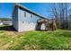 Backyard of blue house with wood deck, stairs, and green grass at 1314 39Th Street Sw Cir, Hickory, NC 28602