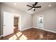 Spacious bedroom with ceiling fan, hardwood floors, and adjacent bathroom at 1314 39Th Street Sw Cir, Hickory, NC 28602