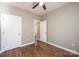 Neutral bedroom features ceiling fan, closet, and wood-look flooring at 1314 39Th Street Sw Cir, Hickory, NC 28602