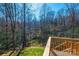 Wood deck overlooking lush greenery and mature trees at 1314 39Th Street Sw Cir, Hickory, NC 28602
