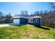 Beautiful blue single-story home with white trim, set on a large, grassy lot with trees in the background at 1314 39Th Street Sw Cir, Hickory, NC 28602