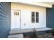 Charming front porch featuring a white door with decorative windows, enhanced by attractive siding and trim at 1314 39Th Street Sw Cir, Hickory, NC 28602