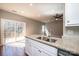 Bright kitchen with granite countertops, stainless steel sink, and sliding glass doors to the outdoor space at 1314 39Th Street Sw Cir, Hickory, NC 28602