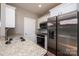 Modern kitchen with stainless steel appliances, granite countertops, and dark kitchenware at 1314 39Th Street Sw Cir, Hickory, NC 28602