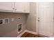 Laundry room with white cabinets, wood-look floors, and utility connections at 1314 39Th Street Sw Cir, Hickory, NC 28602