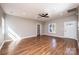 Open-concept living area with hardwood floors, ceiling fan, and natural light streaming through the windows at 1314 39Th Street Sw Cir, Hickory, NC 28602
