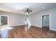 Bright living room with hardwood floors, ceiling fan, and access to the bathroom and outdoor deck at 1314 39Th Street Sw Cir, Hickory, NC 28602